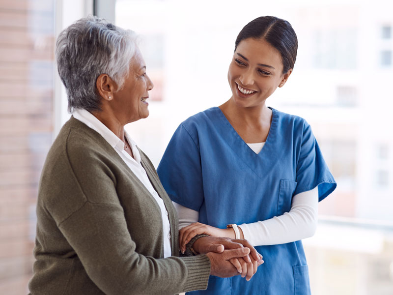a caregiver helping an elderly woman